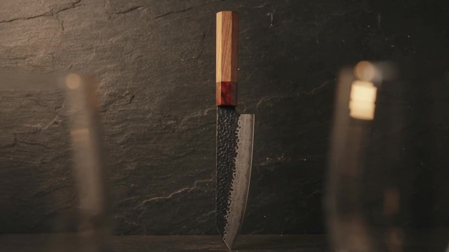 Kuroshio chef knife standing on dark slate